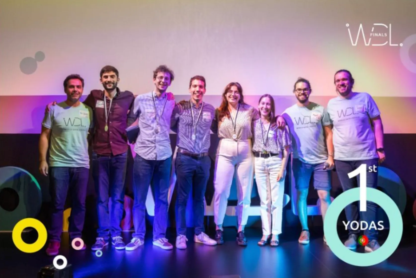 The team on stage at the World Data League finals in 2022, wearing medals.