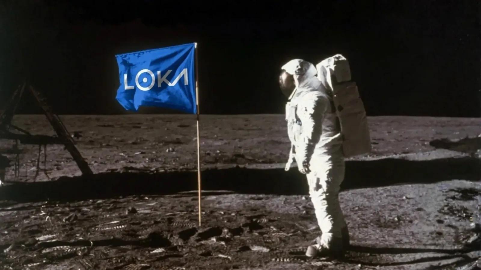 An astronaut on the moon beside a blue Loka flag.