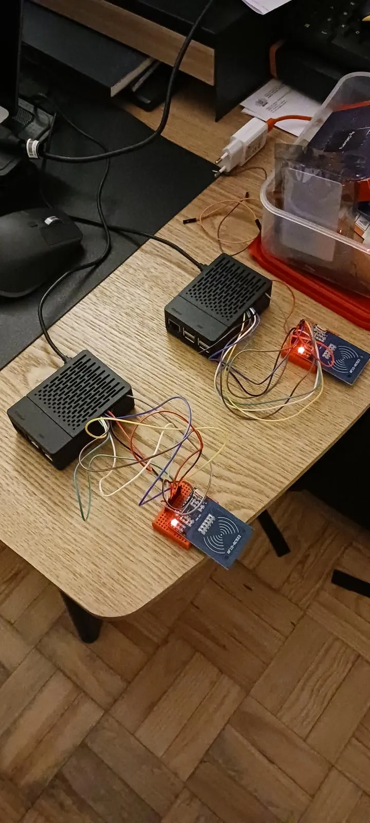 Two Raspberry Pi boards wired to RFID reader modules on a desk, used to control the Loopack smart-bin prototype.